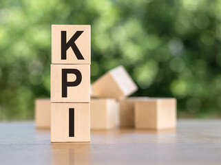 Letter block in word KPI -Abbreviation of key performance indicator on wood background