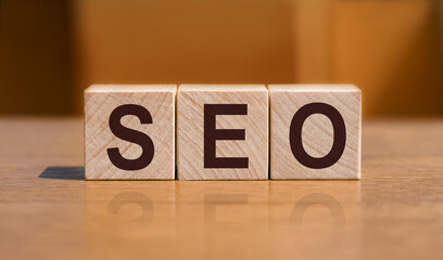 SEO text on wooden cubes on a wood background