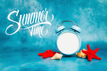 Alarm clock on a blue background with a seashells and starfish with the quote Summer Time