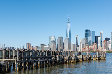 New York City skyline with the World Trade Center in the background and wooden pilings in the foreground.