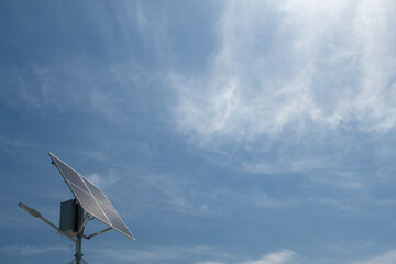 solar panel against blue sky with clouds