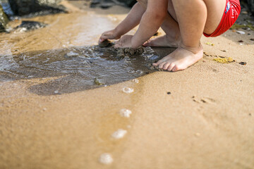 child plays  on the beach