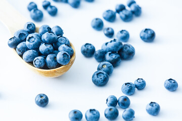 Freshly picked blueberries in wooden bowl. fresh blueberries on a white rustic table. selective focus.