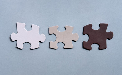 Jigsaw teamwork concept macro shot. Connect couple puzzle piece. Symbol of association and connection, business strategy, completing, team support and help concept. Two wooden puzzles stand together