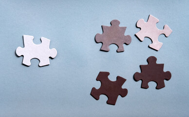 Colored Jigsaw Puzzle pieces on gray background top view. Concept for Unite to end racism. Symbol of association and connection, business strategy, completing, team support and help concept.