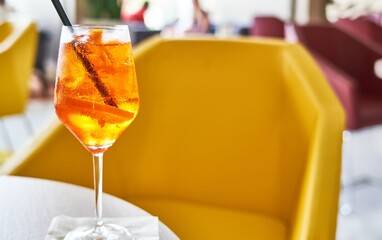 Glass of cold refreshing aperol spritz cocktail on table in summer. 