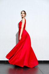 Portrait of girl in waiving red silk dress
