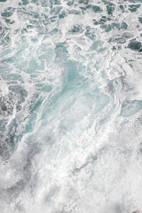 Fototapeta premium Wall mural on the marine theme. Seascape for the interior. White sea foam. The turquoise color of the waves. Stormy Bay of Biscay. The texture of the waves. Spray and the power of the sea.