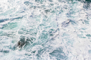 Obraz premium Wall mural on the marine theme. Seascape for the interior. White sea foam. The turquoise color of the waves. Stormy Bay of Biscay. The texture of the waves. Spray and the power of the sea.