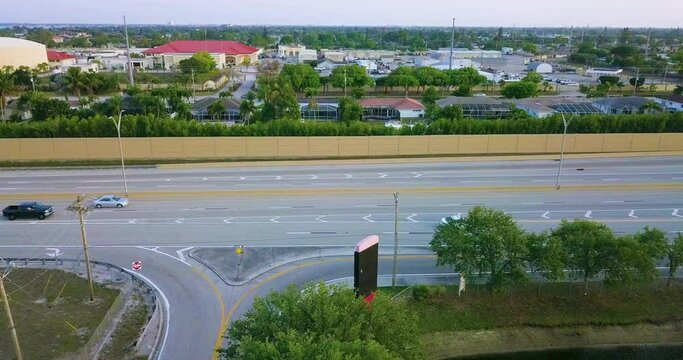 Florida six lane road in Cape Coral. Del Prado Boulevard. Cars driving fifty mph from a drone.