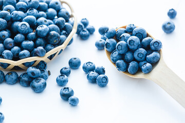 blueberries in bamboo basket on white background