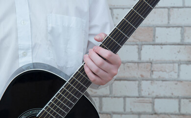 Playing guitar. A man plays the guitar. Close up.