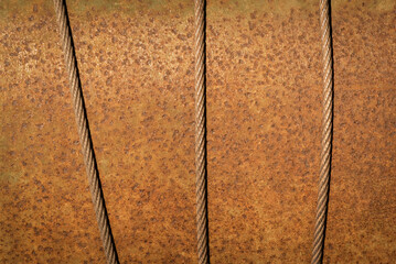 Old rusty metal texture background with steel cables.