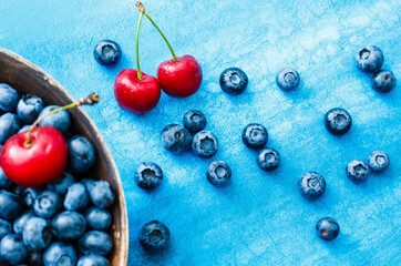 Blueberries on colorful blue background. Can be used for blueberry, blue, color, colorful, vitamin, nutrition, fruit, berries, antioxidant, summer, fun, food themes