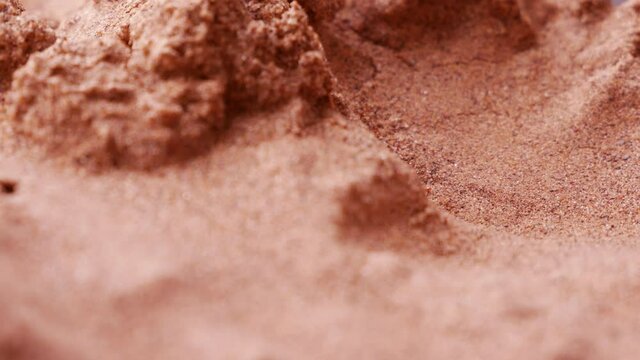 Martian soil close-up. Red sand and dust with iron oxide and perchlorates. Super macro shot, smooth rotation