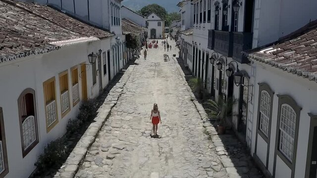 Woman walking through the streets of Paraty, Brazil