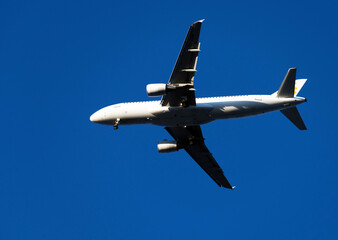 Airplane flying against the blue sky