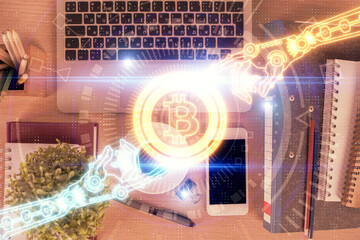 Double exposure of blockchain theme hologram over table with phone. Top view. Crypto technology concept.