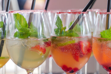 Selected focus at Triple Berry Margaritas or Berry Vodka Cocktails with strawberries, blueberry, blackberry and lime serve on glass with salt on top. 