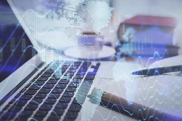 Double exposure of financial chart drawing and desktop with coffee and items on table background. Concept of forex market trading