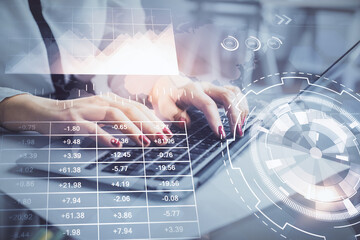 Multi exposure of woman hands typing on computer and financial graph hologram drawing. Stock market analysis concept.