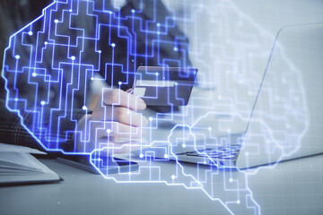 Double exposure of woman on-line shopping holding a credit card and brain hologram drawing. Data E-commerce concept.
