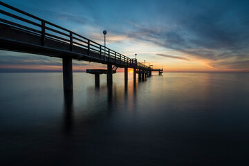 sunset with pier on the baltic sea