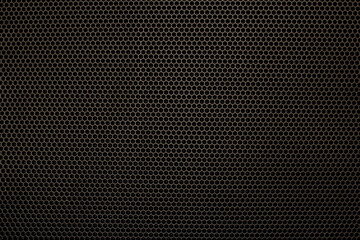 the dark texture of the grid with cells in the form of a hexagon, reminiscent of a honeycomb.