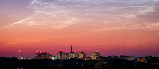 Fototapeta premium Sunrise Cityscape. Beautiful sky and clouds, night illumination of houses. Vladimir city, Russia