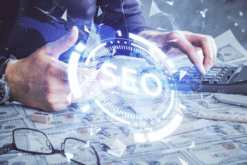 Multi exposure of man's hands holding and using a digital device and seo drawing. search...