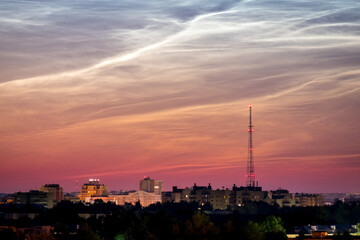Dawn Cityscape. Beautiful sky and clouds, night illumination of houses, silhouette of a telephone tower. Vladimir city, Russia