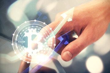 Double exposure of man's hands holding and using a phone and crypto currency blockchain theme drawing.