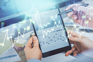 Multi exposure of man's hands holding and using a phone and financial chart drawing. Market analysis concept.
