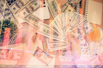Multi exposure of financial graph drawing hologram and USA dollars bills and man hands. Analysis concept.