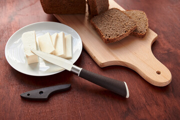 healthy food - fresh bread and feta cheese on a wooden background