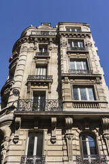 Old French house with traditional balconies and windows. Paris, France.