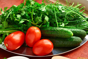 healthy food - fresh vegetables and greens on a wooden background, greens, onion and tomatoes