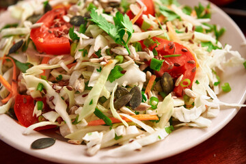 healthy food - fresh chopped vegetables on a wooden background, tomatoes and greens