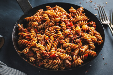 Pasta penne with sauce and meat served on pan