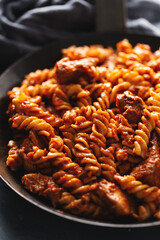 Pasta penne with sauce and meat served on pan