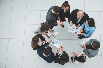 top view. group of corporate employees standing in a circle.