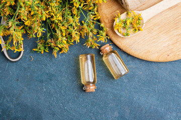 Medicinal herb St. John's wort and tincture in bottles. Herbal treatment and natural cosmetics...