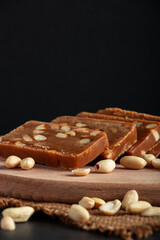 Peanut home toffee on a wooden board. Slices of eastern sweets with nuts.
