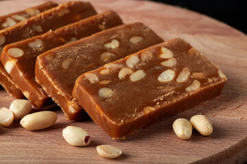 Peanut home toffee on a wooden board. Slices of eastern sweets with nuts.