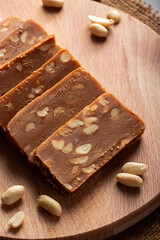 Peanut home toffee on a wooden board. Slices of eastern sweets with nuts.