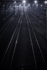 Obraz na płótnie Canvas railway tracks night landscape at the railway station fog autumn