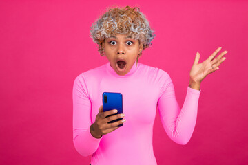 amazed woman with mobile phone isolated on background