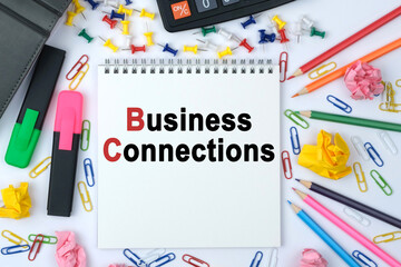 On the table is a calculator, diary, markers, pencils and a notebook with the inscription - Business Connections