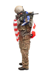 Naklejka premium American soldier in uniform and with a rifle aims and shoots, a special forces soldier with the USA flag with weapons on a white background
