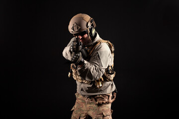 portrait of special forces in a military uniform with weapons at night, elite troops, counter terrorist against a dark background